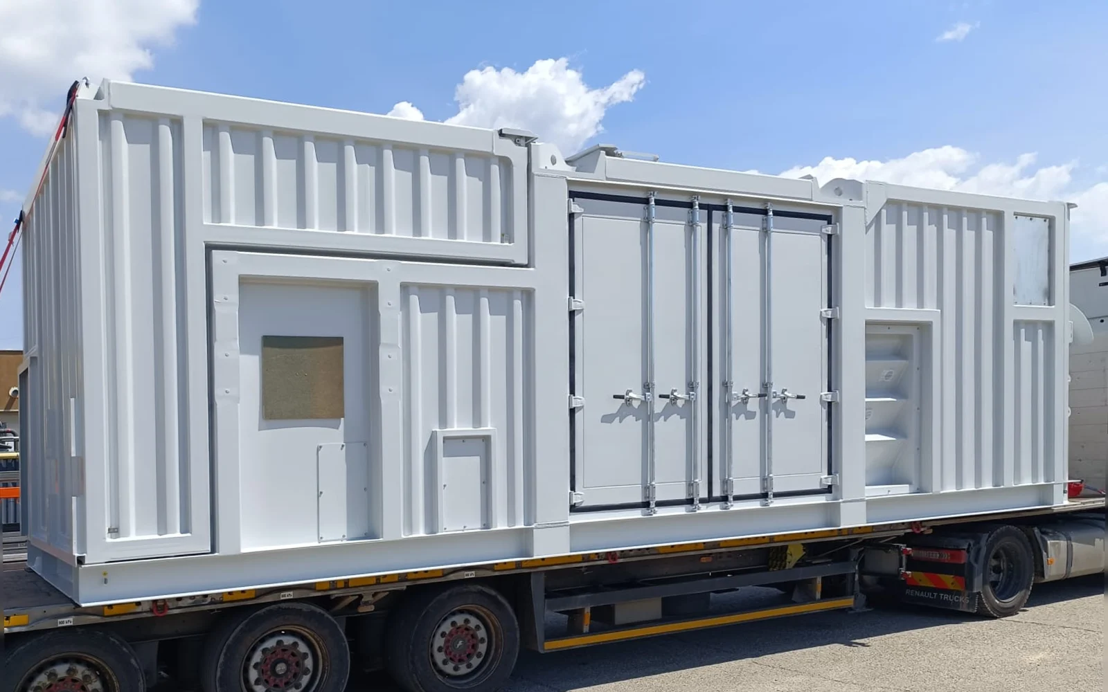 Finished white mud pump enclosure loaded on a truck trailer